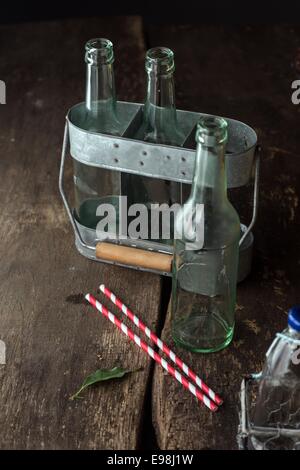 Macro schießen Transparent Leergut auf Vintage Holztisch. Einsatzbereit für alle Flüssigkeiten wie Saft oder Milch. Stockfoto