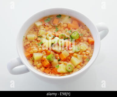 Gesunden Teller Linsen, Karotten und Lauch Suppe reich an Protein und diätetische Faser, erhöhte Ansicht auf weiß Stockfoto