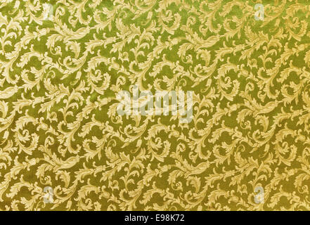 Zusammenfassung Hintergrund aus einem schweren gelb grün Brokatstoff mit verwobenen wiederholen Design. Stockfoto