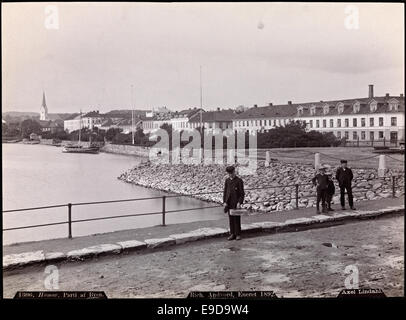 Foto von Hamar, Norwegen, aufgenommen um 1892 von Axel Lindahl, zeigt einen Teil der Stadt mit Jungen im Vordergrund, was die Landschaft und die frühe Stadtentwicklung hervorhebt. Stockfoto