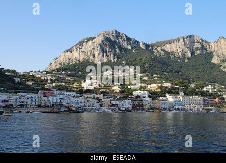 Boote und Gebäude der Marina Grande auf der Insel Capri, Italien, mit Bergen im Hintergrund Stockfoto