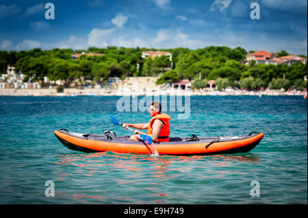 Junge Männer Paddel Kajak auf dem Meer Stockfoto