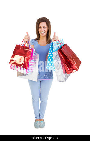 Frau mit Einkaufstüten mit den Daumen nach oben Stockfoto