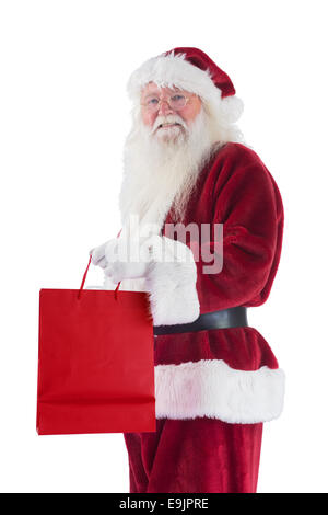 Santa trägt rote Geschenktüte Stockfoto