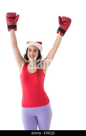 Festliche Brünette in Boxhandschuhen jubeln Stockfoto