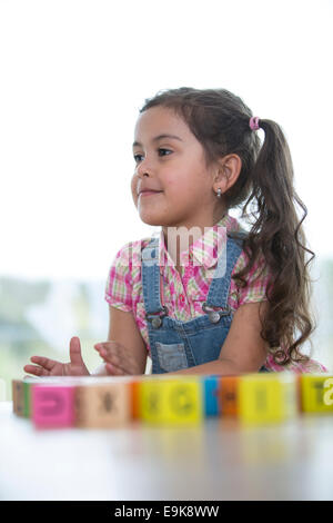 Kleine Mädchen spielen mit Blöcken zu Hause Stockfoto