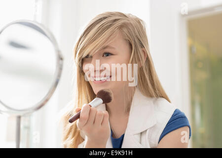 Mädchen beim Schminken vor dem Spiegel zu Hause Stockfoto