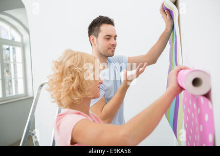 Paar hält Tapete Proben im neuen Haus Stockfoto