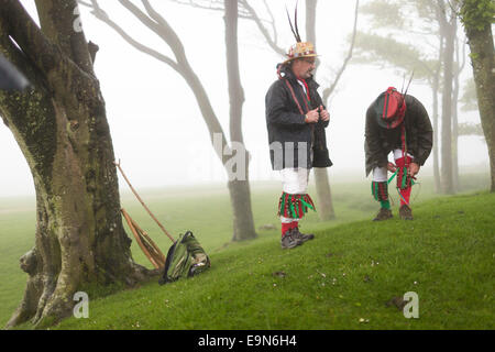 Mitglieder der Chanctonbury Ring Morris Männer machen die lange, steile Wanderung im Regen ihre traditionellen Tänze der Maifeiertag, durchführen Stockfoto