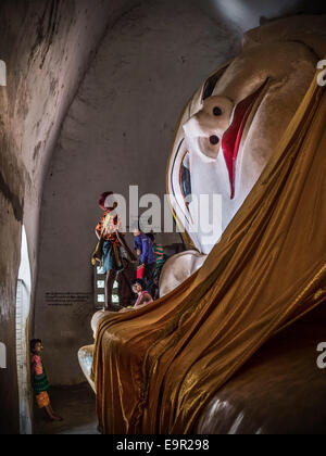 Lokalen burmesischen Kinder untersuchen alten liegende Buddha-Statue im Manuha Tempel in Bagan, Myanmar (Burma). Stockfoto