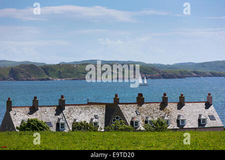 Segelboot, die Dächer der Häuser auf Isle of Iona in den Inneren Hebriden und Western Isles, Westküste von Schottland vorbei Stockfoto