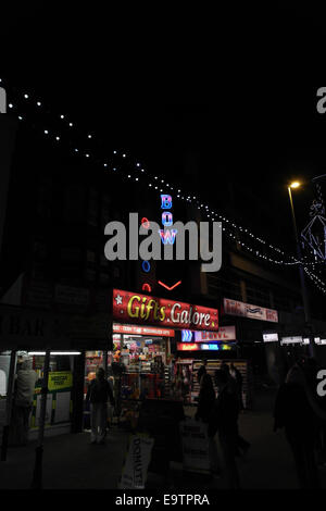 Nacht Schrägansicht, Blick nach Süden, Bürgersteig Menschen, Geschenke in Hülle und Fülle-Shop und MFA Schüssel, zentralen Promenade Blackpool Illuminations Stockfoto