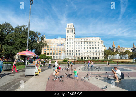 Placa Catalunya mit seiner typischen Tauben flattern, während Touristen fotografieren, spazieren oder Ruhe in Barcelona, Katalonien, Spanien Stockfoto