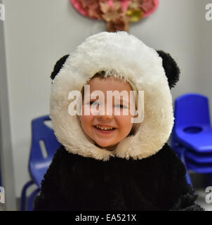 Portrait eines lächelnden jungen in einem Panda Kostüm Stockfoto