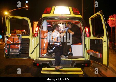 Jerusalem, Israel. 6. November 2014. Ein Israeli wird in einem Krankenwagen in der Nähe der Stelle behandelt wo eine Ammoniak-Leck im Meatpacking Werk im Industriegebiet von Hefer Tal, zentral-Israel am 6. November 2014 ereignete. Ein Feuerwehrmann starb und mindestens 16 Menschen wurden bei dem Unfall am Donnerstagabend verletzt, sagte Beamten Xinhua. © JINI/Nimrod Glikman/Xinhua/Alamy Live-Nachrichten Stockfoto