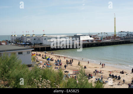 Ein Blick von der oberen Promenade Clacton-on-Sea Pier und Strand an einem sonnigen Tag. Besucher erfreuen sich den Sandstrand. Stockfoto