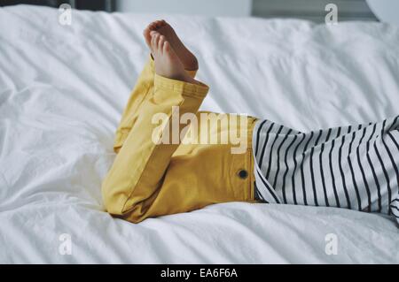 Seitenansicht eines Jungen, der auf dem Bett liegt Stockfoto