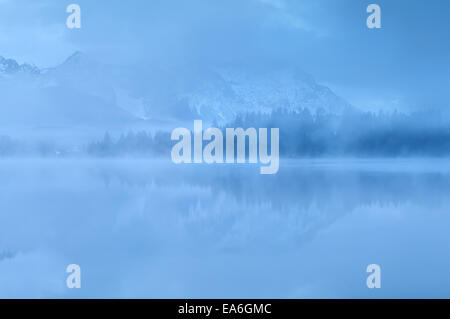 Berge im See in der Abenddämmerung Nebel, Deutschland widerspiegelt Stockfoto
