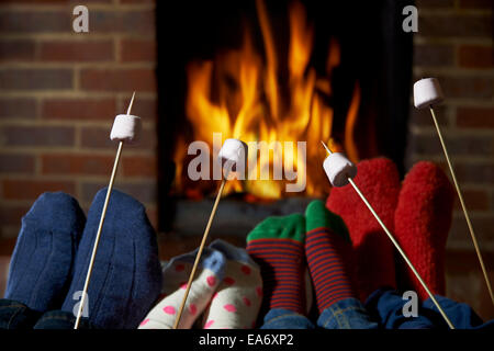 Familie Rösten Marshmallows von offenem Feuer zu Hause Stockfoto