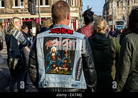 Die Rückansicht eines jungen Mannes mit einer schwarzen Leder und Denim Jacke mit der Heavy-Metal-Bands Motley Crue und Skid Row. Stockfoto