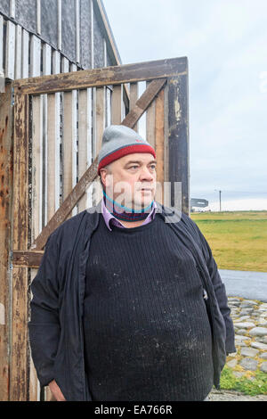 Lokale Fischer steht vor Tür seine Fische trocknen Haus entlang der Uferpromenade von Reykjavik, Island. Stockfoto