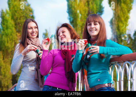 Drei junge schöne Frauen sprengen Luftblasen Stockfoto