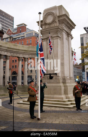 Belfast, Nordirland. 9. November 2014. Ein Hornist spielt den letzten Beitrag, während die Nationalflagge auf Halbmast, zum Gedenken an den nationalen Tag des Gedenkens gesenkt wird Stockfoto