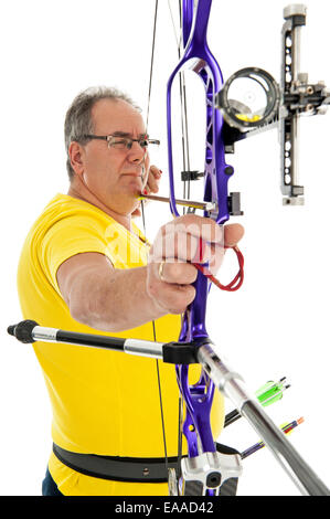 Mann mit gelben Hemd und Jeans mit Pfeil und Bogen in der Nähe mit dem Ziel Stockfoto