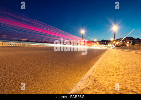 Bewegenden Autos mit Unschärfe Licht durch die Stadt bei Nacht. Stockfoto