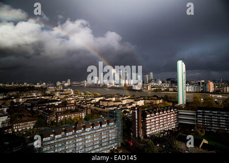 London, UK. 12. November 2014.  Regenbogen über Canary Wharf Geschäftshäuser Credit: Guy Corbishley/Alamy Live News Stockfoto