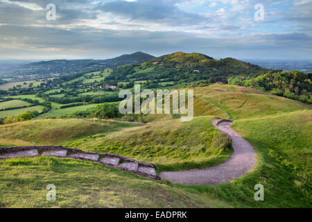 Die Stadtmauer der historischen Wallburg der britischen Lager, Herefordshire Beacon, sind mit dem starken Licht aus den Sonnenuntergang beleuchtet Stockfoto