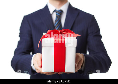 Geschäftsmann im Anzug hält Geschenkbox von roten Schleife gebunden Stockfoto