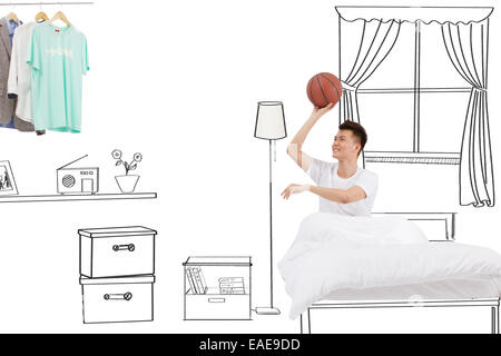 Pitching jungen Mann auf dem Bett Stockfoto