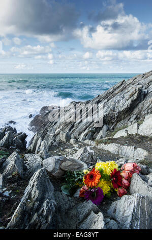 Ein Bouquet von Blumen links auf Felsen auf Towan Landzunge in Newquay, Cornwall. Stockfoto