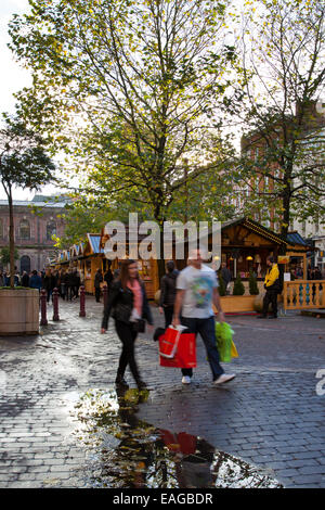 Festliche Verkaufsstände in Manchester UK, 14. November 2014. St. Annes Square am Eröffnungstag des Weihnachtsmarktes auf dem St Ann's Square, der Käufer aus Großbritannien und anderen Ländern anzieht. Dieser Markt hat die Innenstadt von Manchester fest auf die Weihnachtskarte gesetzt - der Weihnachtsmarkt ist nicht nur ein fabelhafter Ort zum Einkaufen geworden, sondern auch ein enorm beliebter Urlaubsort auf eigene Faust. Es wird vorgeschlagen, dass der Mancunian Winter komplett ist, ohne durch die von Chalets gesäumten Straßen der Märkte zu schlendern, die ANGEBOTSSTRATEGIE bei der Arbeit für die Erneuerung der Fußgängerzone im Stadtzentrum. Stockfoto