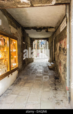 eine schmale und schmutzigen Gasse mit Graffiti in Venedig, Italien Stockfoto