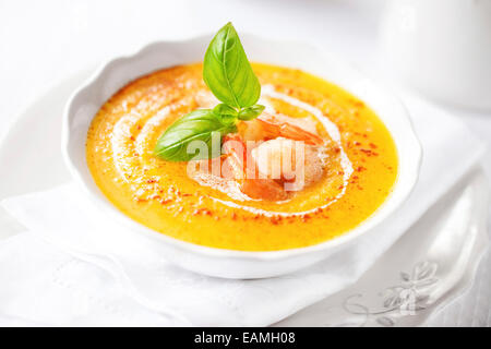Kürbissuppe mit Garnelen und Basilikum Stockfoto