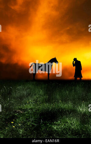 Pferd und Cowboy bei Sonnenuntergang Stockfoto