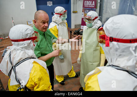 Würzburg, Deutschland. 3. November 2014. Anästhesist aus dem medizinischen missionarischen Institut, Norbert Gresser (2.v.l), demonstriert der Teilnehmer korrekte Behandlung von Ebola-Patienten auf eine Ebola-Fortbildungsseminar in Würzburg, Deutschland, 3. November 2014. Nach der Bundeswehr hat renommierte das einzige Ebola-Training-Center bis heute. Deutsche Entwicklungshelfer in Krisengebieten und in deutschen Isolierung Stationen trainieren hier. Foto: DANIEL KARMANN/Dpa/Alamy Live News Stockfoto