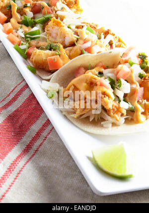 Shrimp Tacos auf einem roten und weißen Teller Stockfoto
