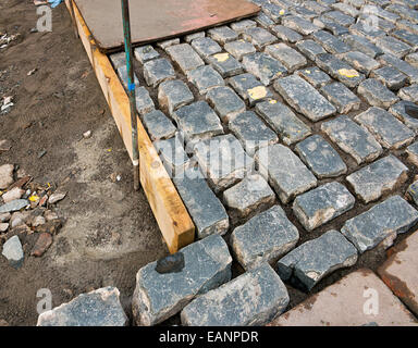 Traditionelle Kopfsteinpflaster Fahrt per hand von erfahrenen Handwerkern in der Baubranche verlegt werden. Stockfoto