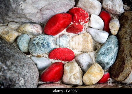 Eine Nahaufnahme von oben aus bunten Kieseln und Felsen. Die Farben der Kieselsteine variieren von blau-grau, Orange und rot Stockfoto