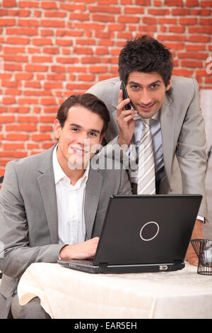 Junge Männer, die mit einem Laptop in einem restaurant Stockfoto
