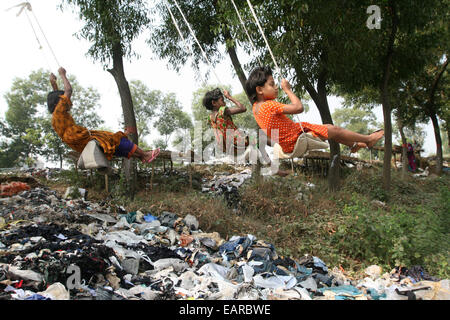 Kinder aus Bangladesh Swing aus einem Baum in Dhaka, Bangladesch ist eines der ärmsten Länder der Welt mit 40 Prozent der 144 Millionen Menschen, die von weniger als 1 Dollar am Tag. Stockfoto