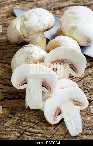 Champignon kultiviert in Scheiben geschnitten auf Ol Holztisch Stockfoto