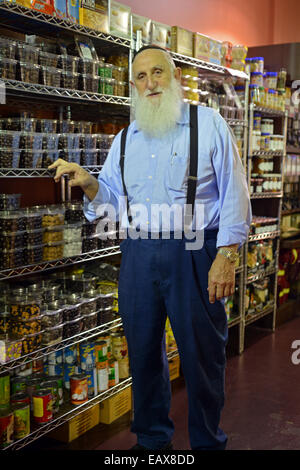 Religiöse jüdische Inhaber eines kleinen koscheren Supermarkt in der Crown Heights, Brooklyn, New York Stockfoto
