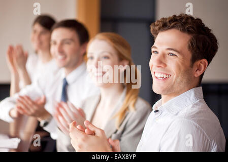 Junge Geschäftsleute applaudieren bei treffen Stockfoto