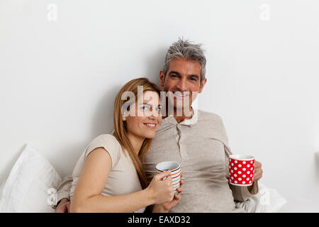 Glückliches Paar Teetrinken im Bett Stockfoto