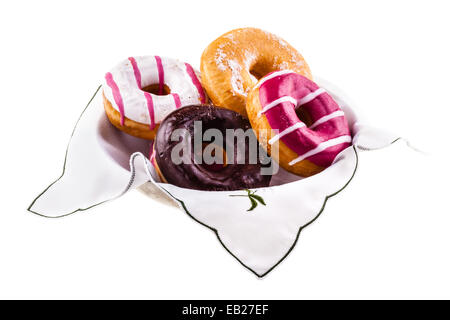 eine Sammlung von leckeren und bunten Donuts auf einem Teller Stockfoto