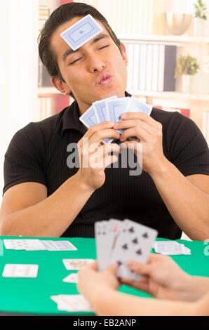 junger Mann Spiel Karten Cuarenta traditionellen ecuadorianischen Stockfoto